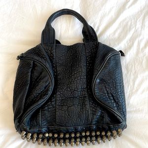 Well loved Alexander Wang bag, 2014. Shoulder strap included. Needs minor repair